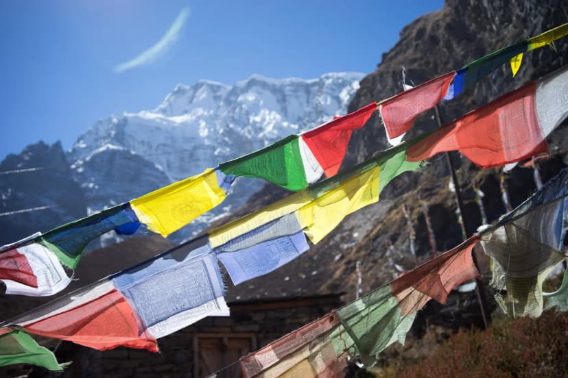 Lungta Tibetan prayer flags against a mountain backdrop