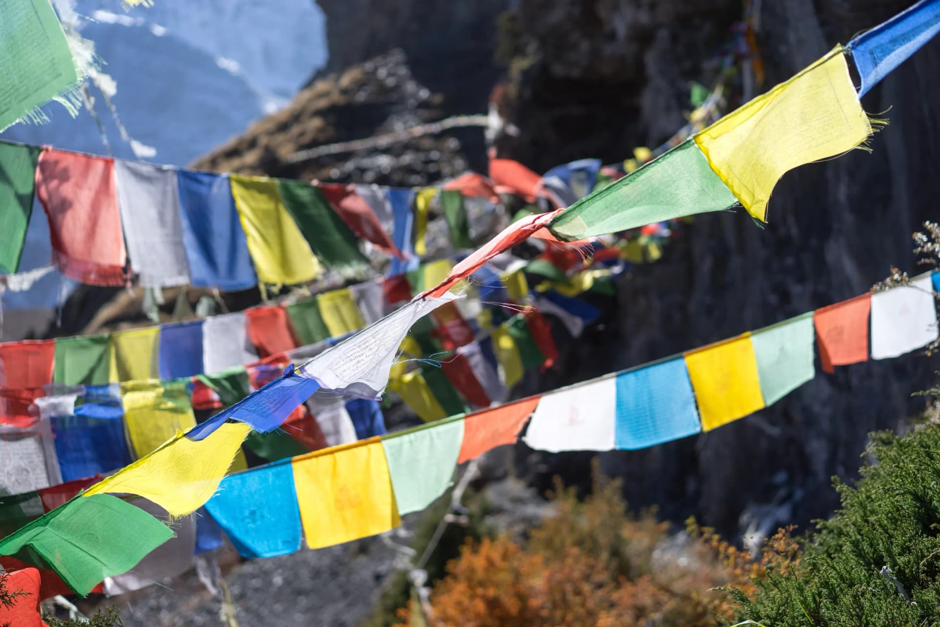 Tibetan prayer flags against a mountain backdrop